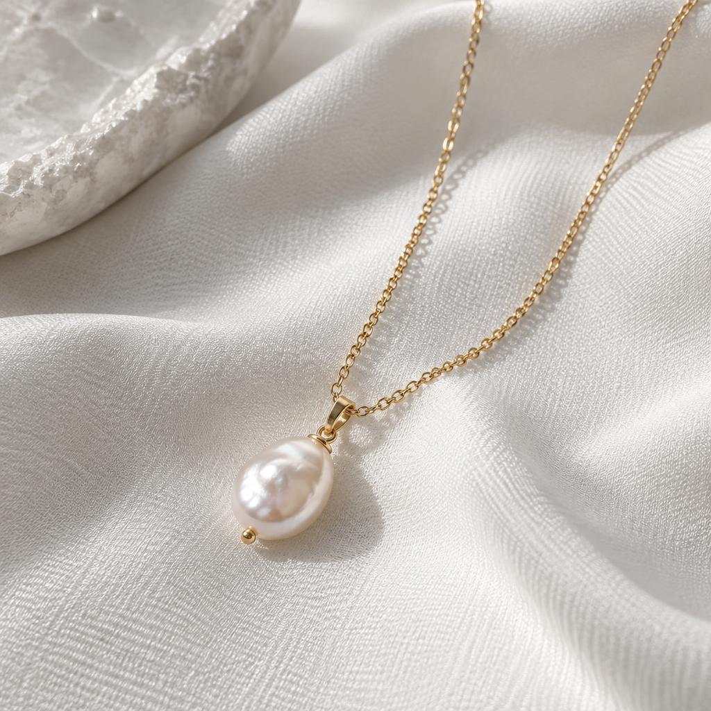 A delicate gold necklace with a freshwater pearl pendant